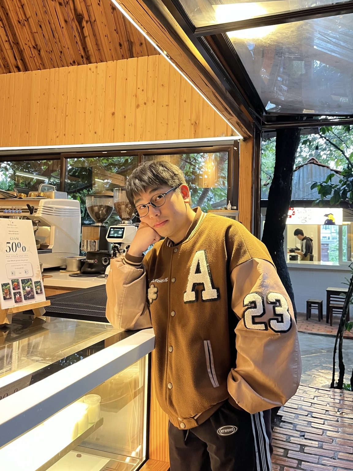 Portrait of Tran Anh Khoi at a cafe